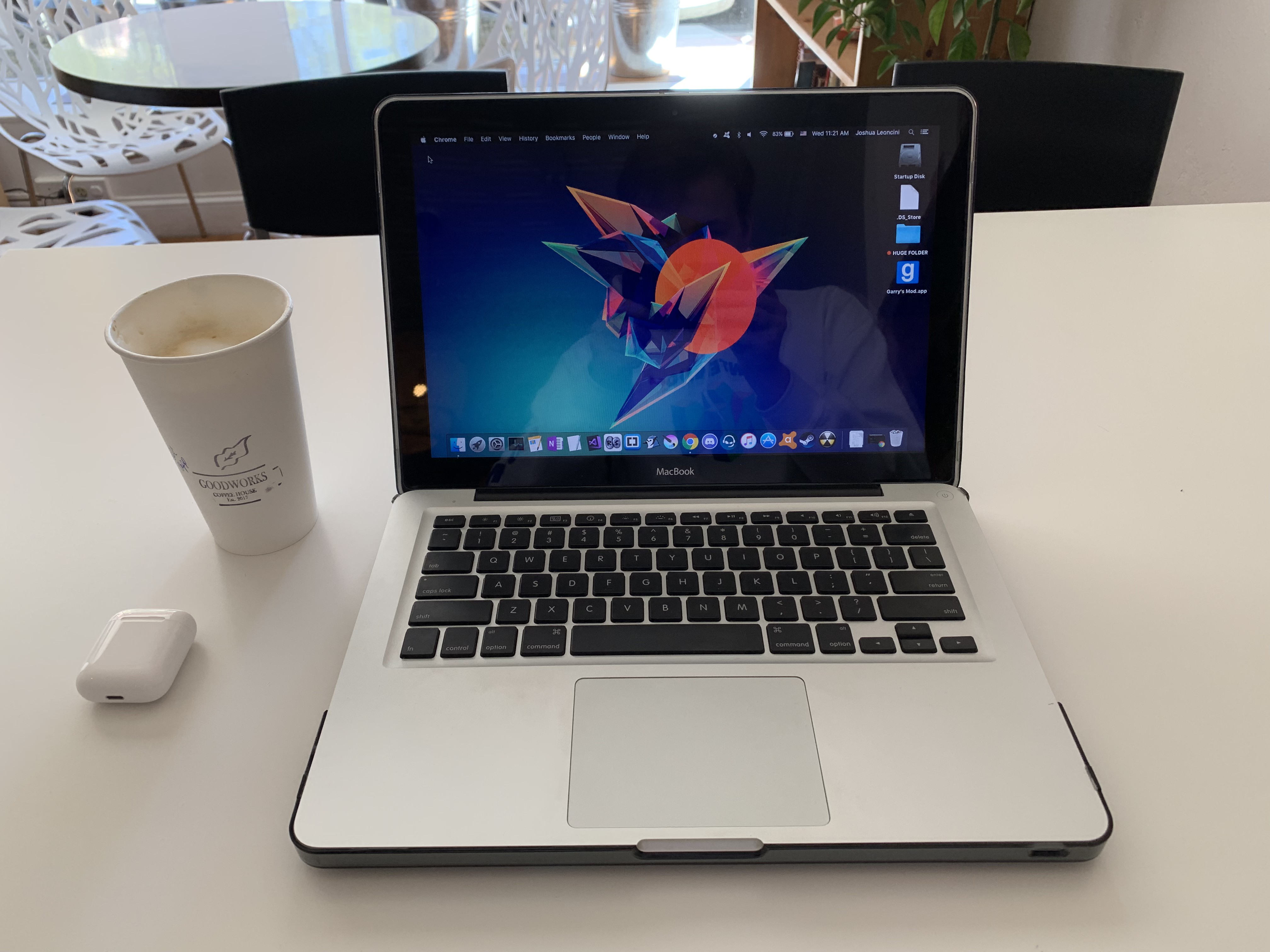 Laptop open with coffee by it's side