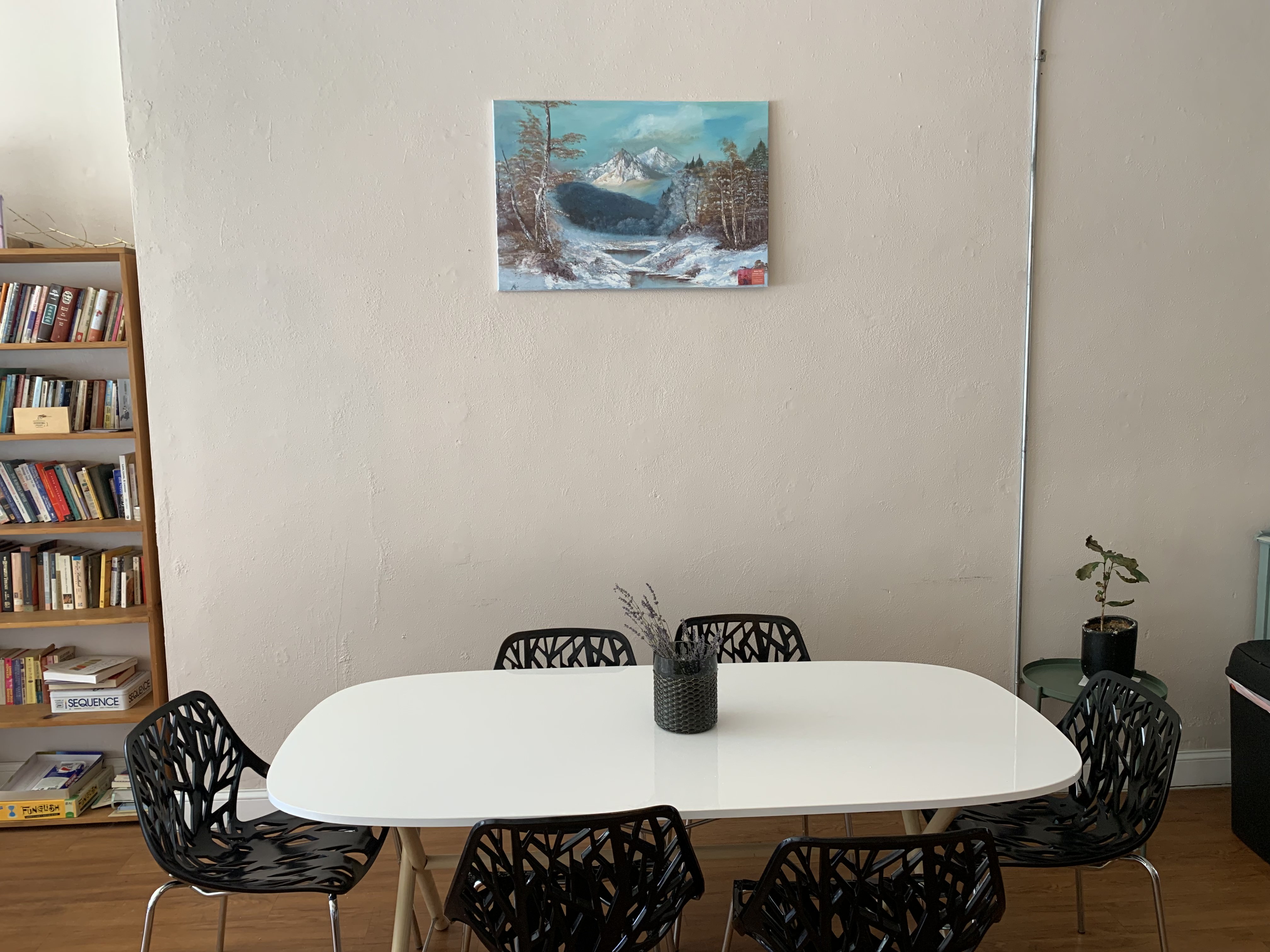 Table with seats next to painting